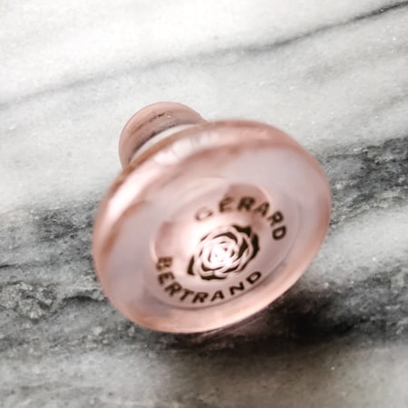 pink glass cork from Gerard Bertrand rose bottle on marble background
