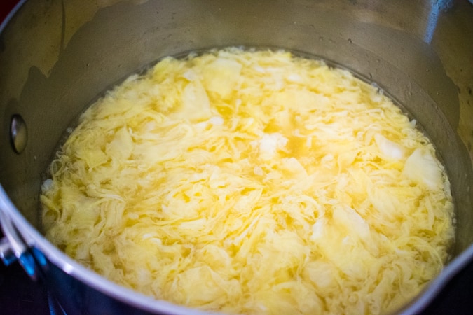 egg drop soup in a stainless steel pot