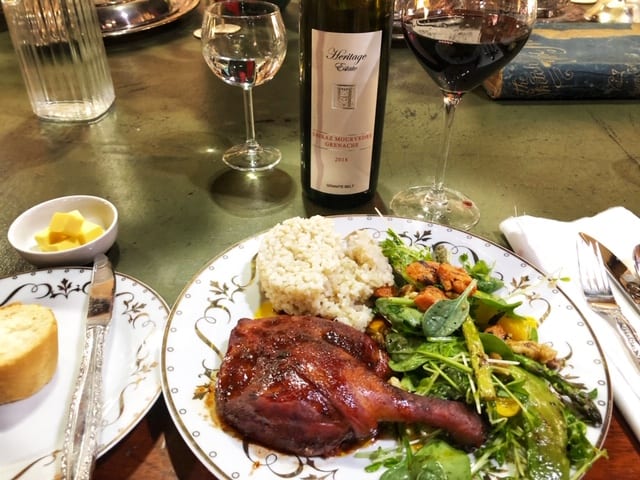 Braised peking duck leg with salad and wine