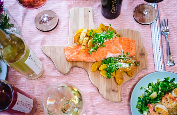Texas cutting board with salmon and squash with selection of Pedernales Cellars wines