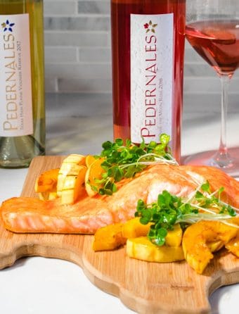 Salmon on a cutting board with Rose and Viognier from Pedernales Cellars