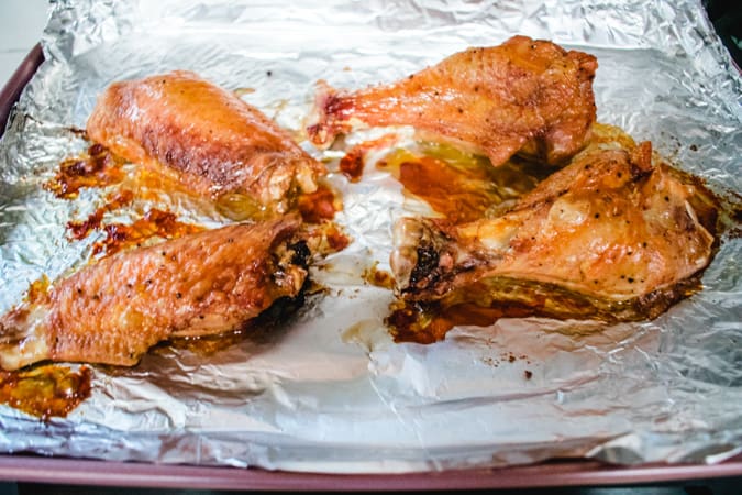 Roasted turkey wings on a foil baking sheet
