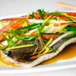 chinese steamed fish on a white platter