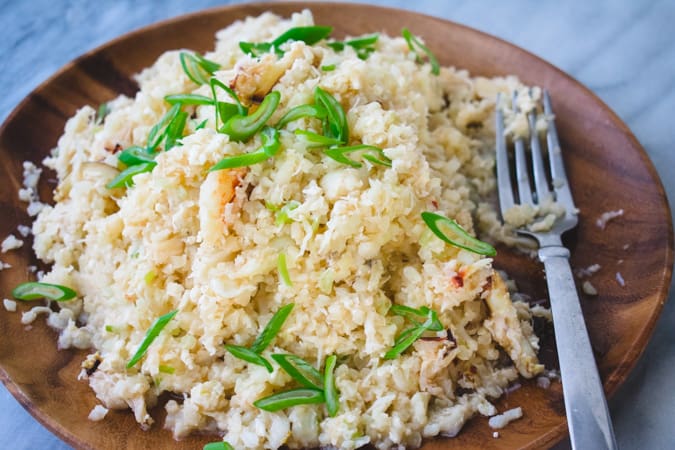 plate of crab and cauliflower fried rice on a brown plate