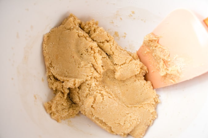 chinese almond cookie dough in a bowl with spatula