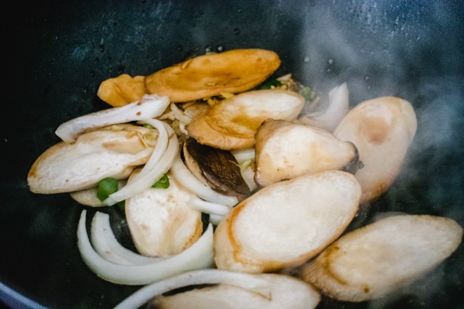 raw mushroom and onion in the wok