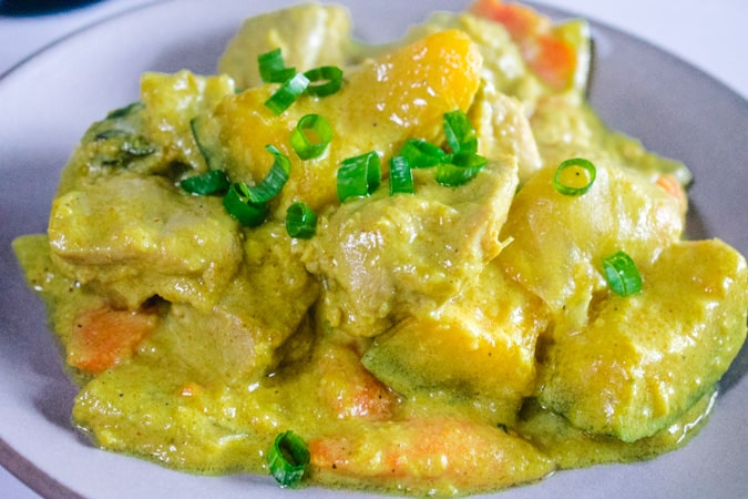 round plate of Burmese yellow chicken curry