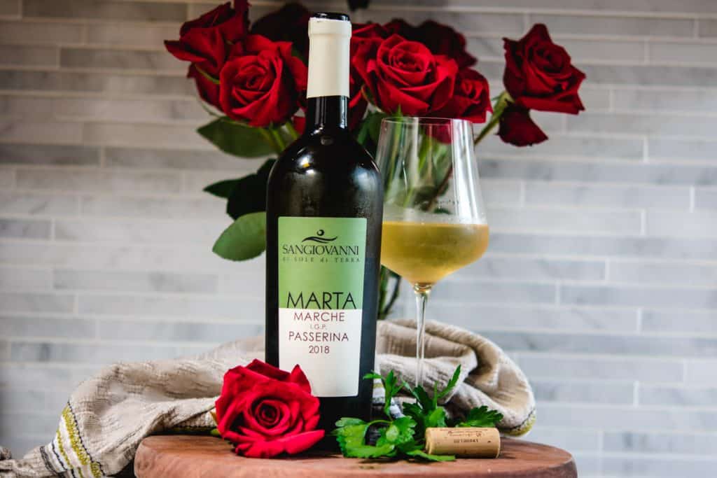 Passerina white wine bottle and glass with red roses