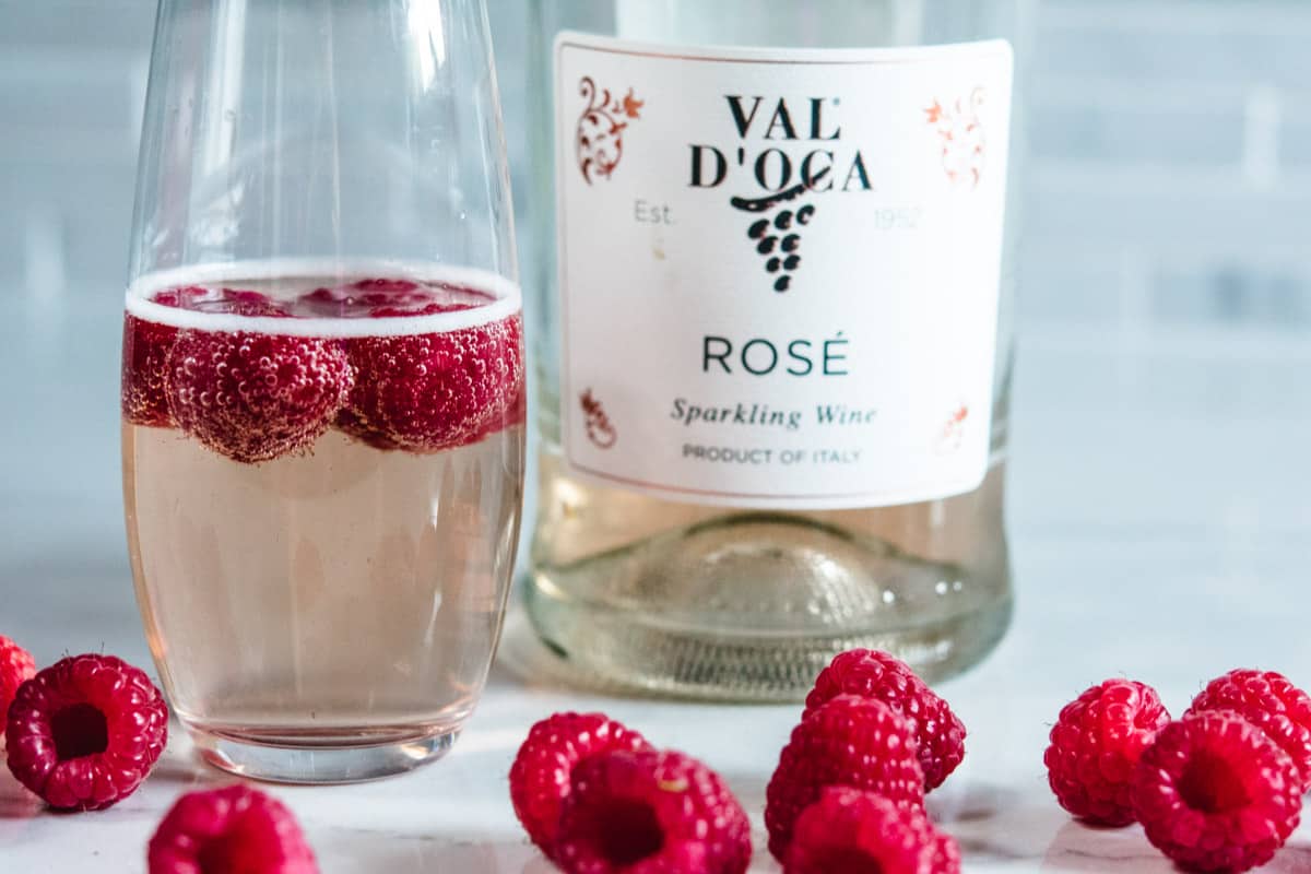 Close up of Italian sparkling rose wine and flute with raspberrie