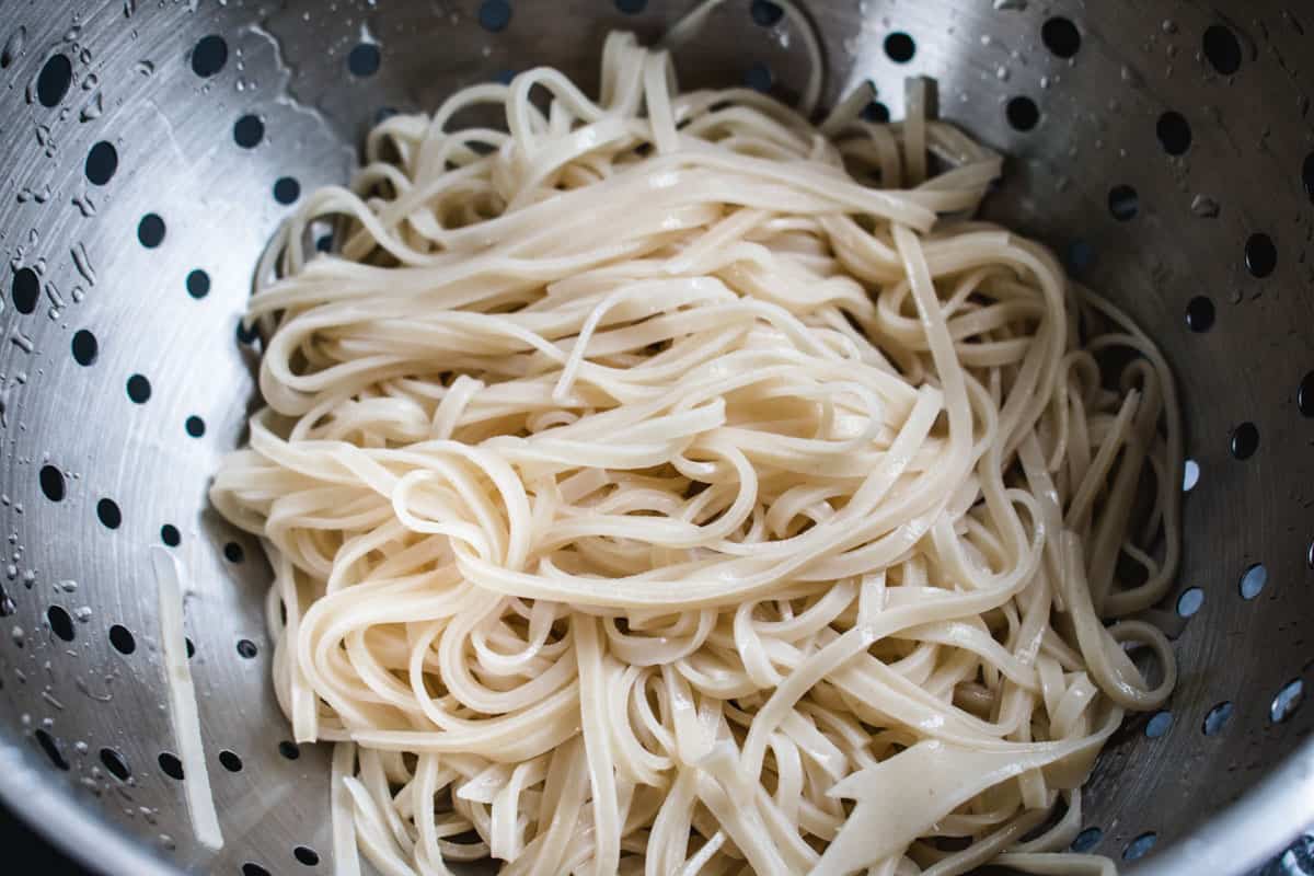 drained rice noodles in a strainer