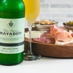 close up shot of mayador cider with charcuterie board